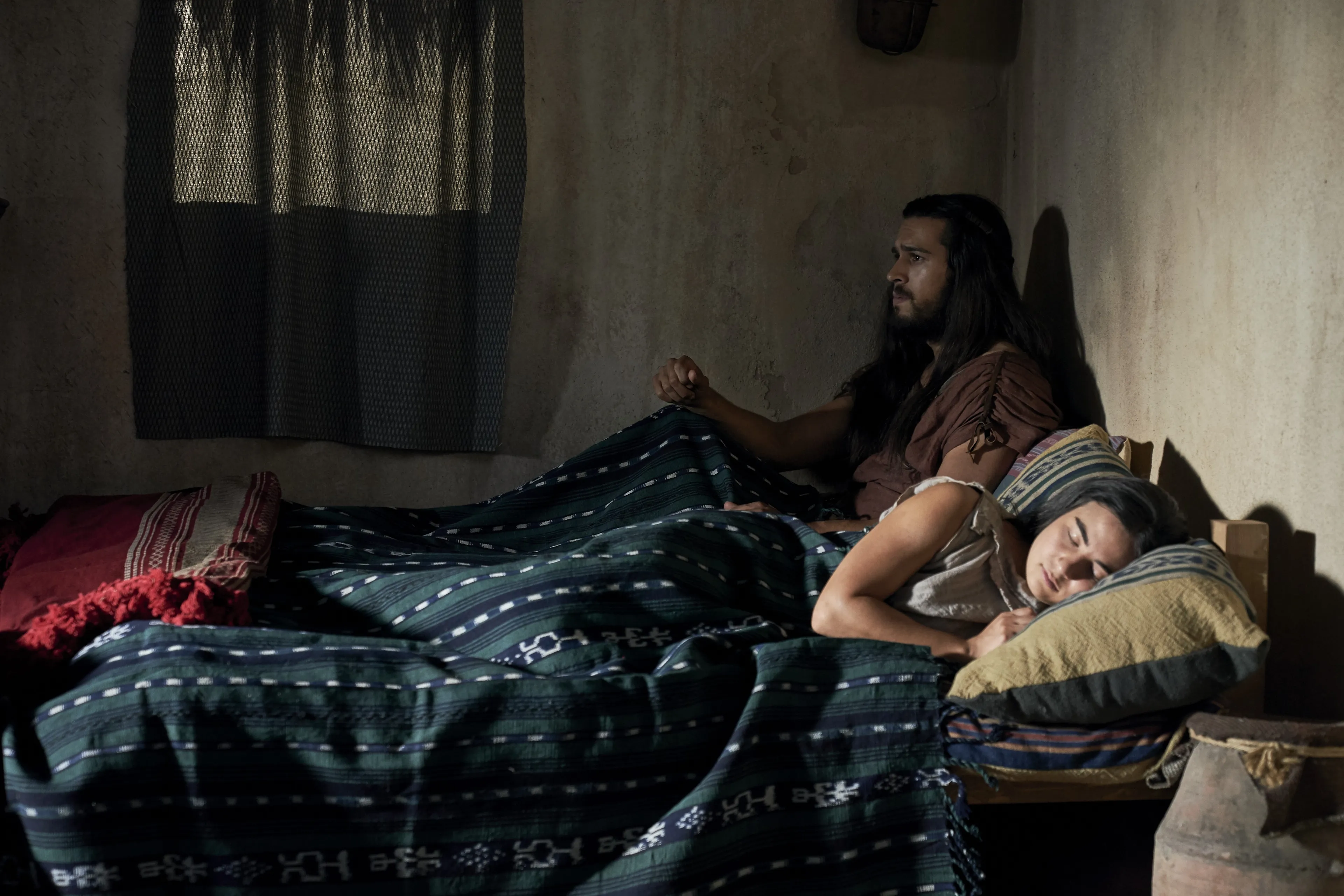 Enos sits in bed before going hunting.