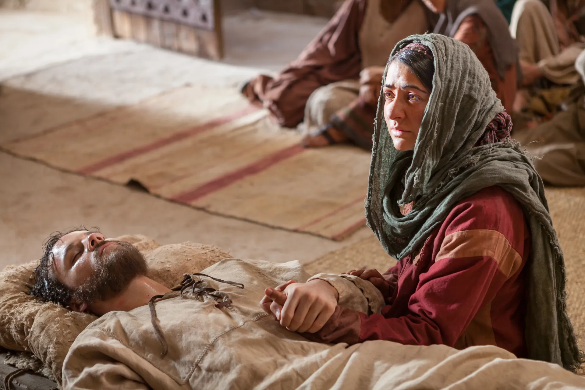 Mary sits by the sick bed of Lazarus.