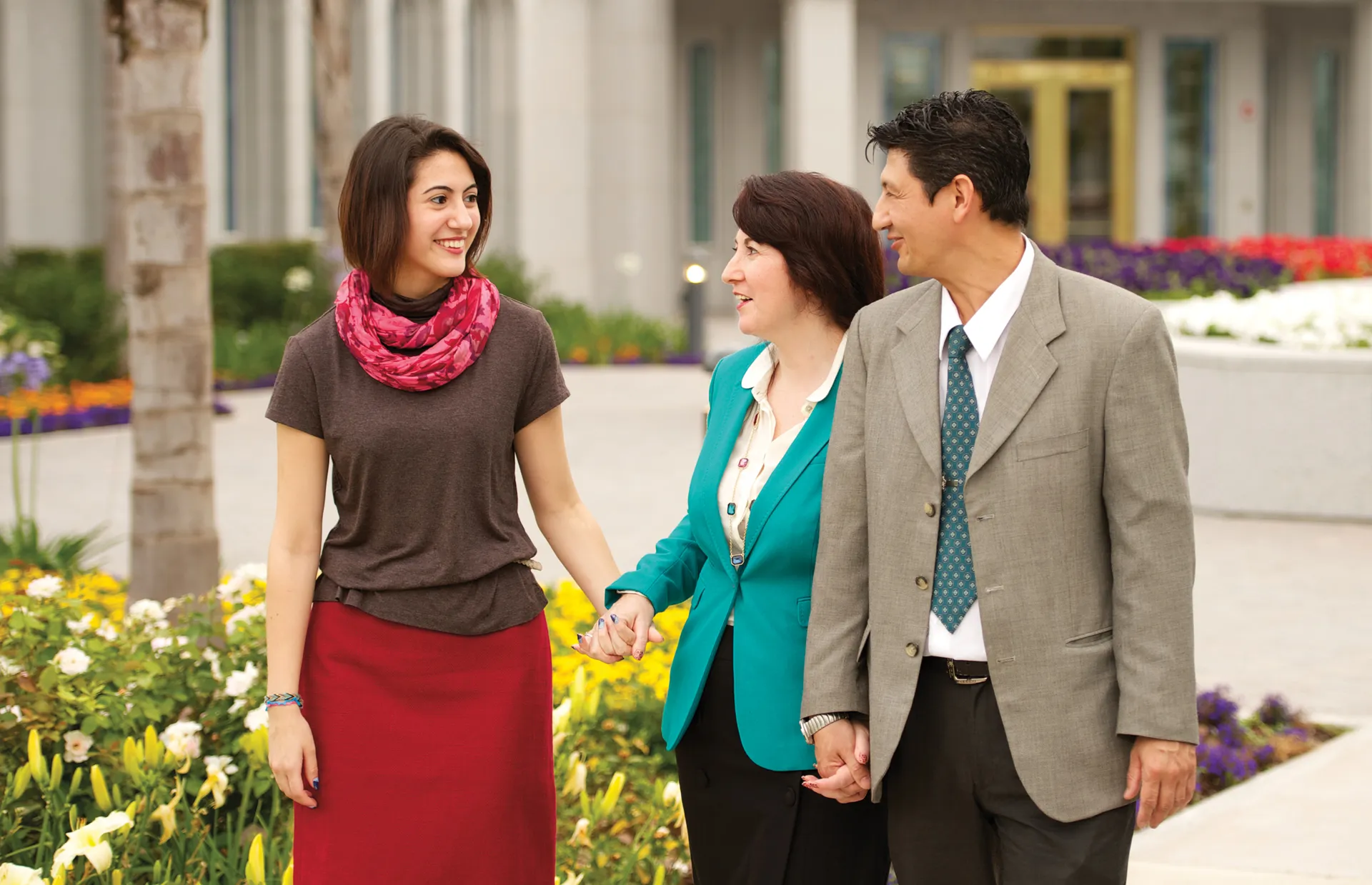 A mother and father go to the temple with their daughter.