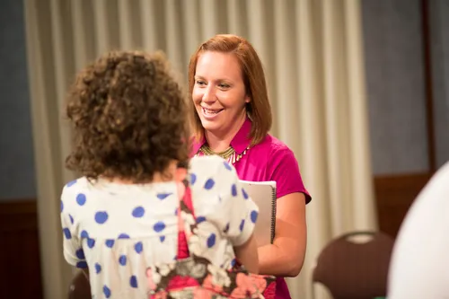Men and women meeting together in an addiction recovery program.