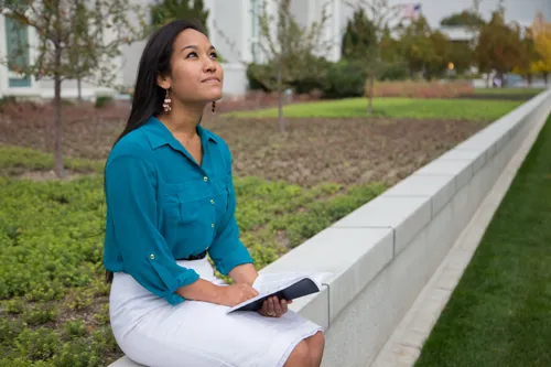 young woman sitting outside the temple