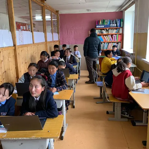 students sitting at desks with computers