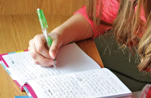 youth writing in a journal
