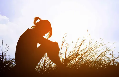 woman sitting with head bowed