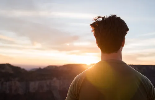 man looking at sunset