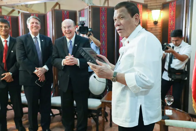 Philippine President Rodrigo Roa Duterte receives a leather-bound copy of the Book of Mormon from Elder Quentin L. Cook of the Quorum of the Twelve Apostles at the Malago Clubhouse at Malacañan Palace, Wednesday, January 15, 2020.