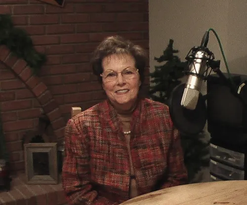 Carolyn Miller beside a radio microphone.