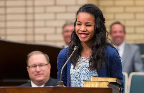 girl talking at the pulpit