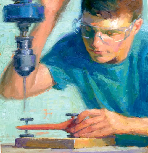 young man using a power drill