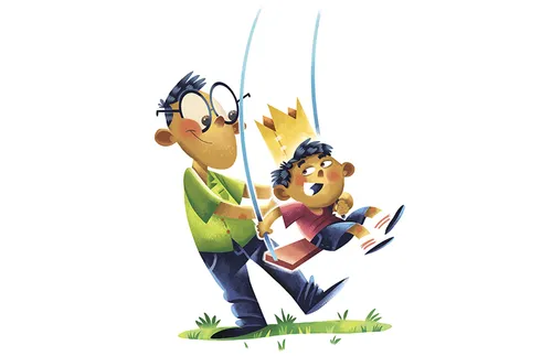 dad pushing boy on swing