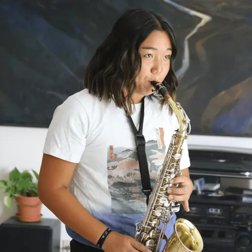 young woman playing saxophone