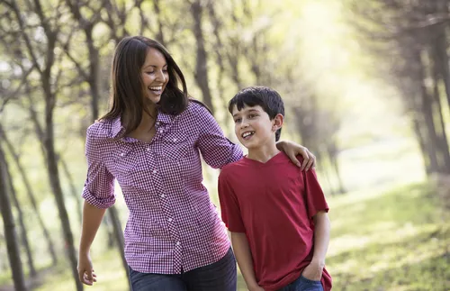 mother and her son walking down a path