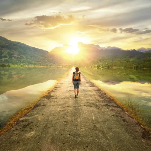 young woman walking down road