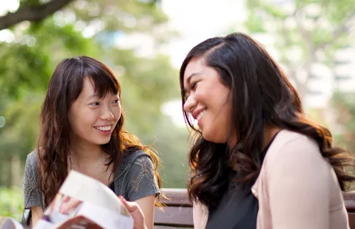 women looking at magazine