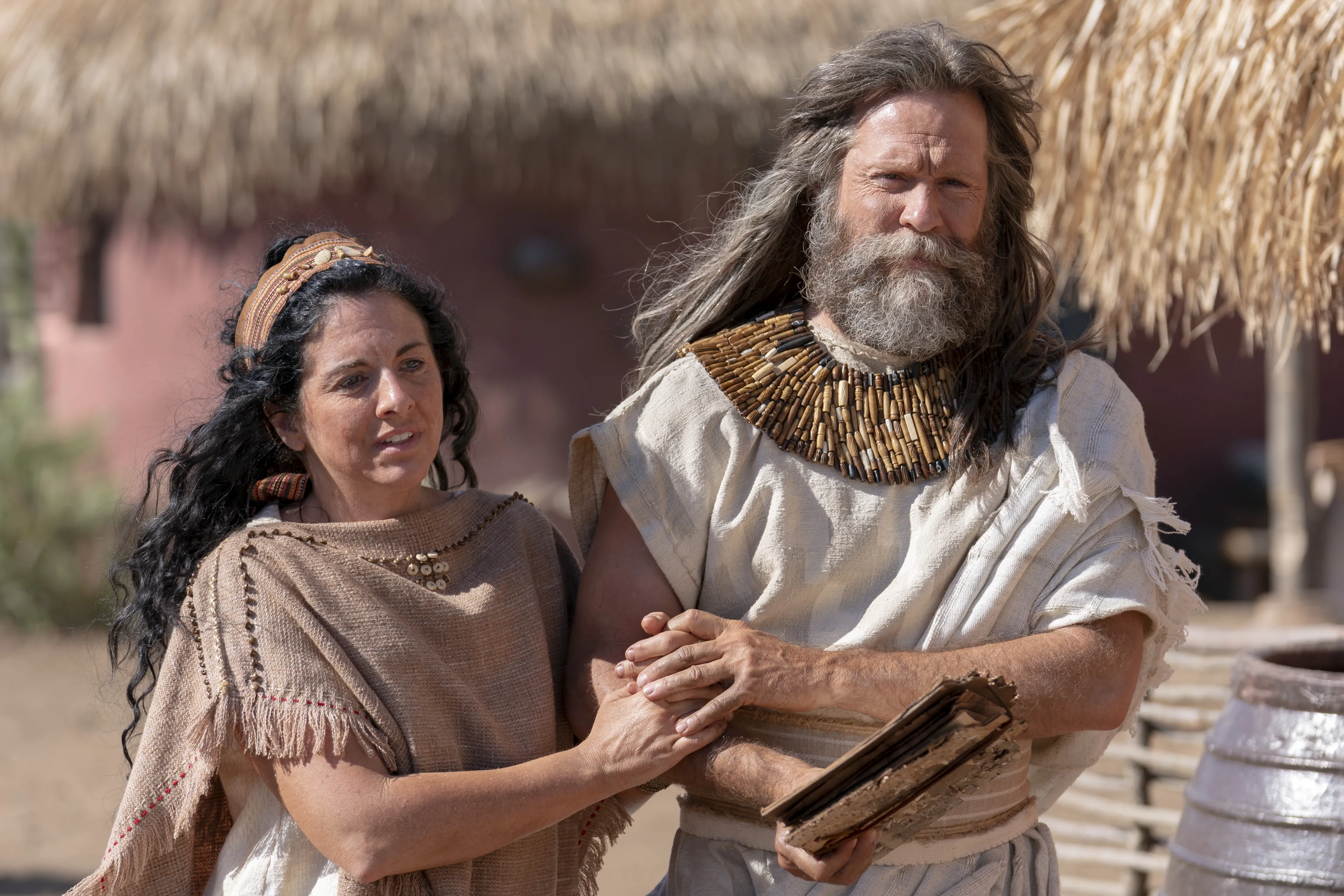 Jacob walks arm in arm with his wife.