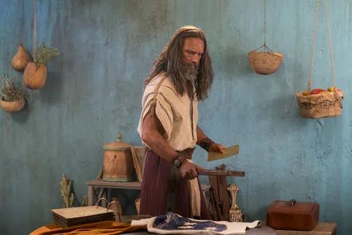 Nephi carries metal plates.