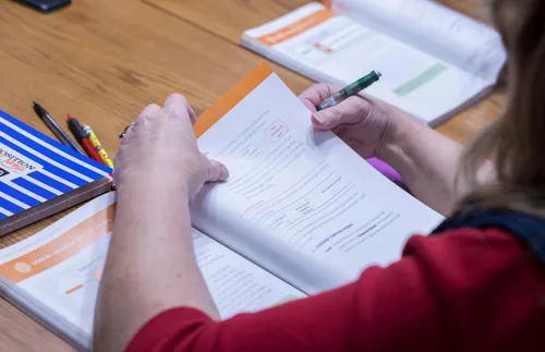 young woman reading self-reliance manual