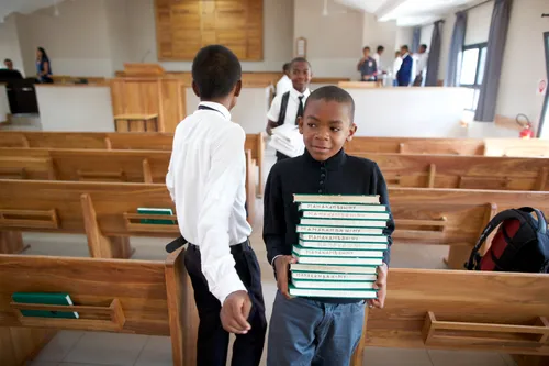 young men gather the hymnbooks after sacrament meeting
