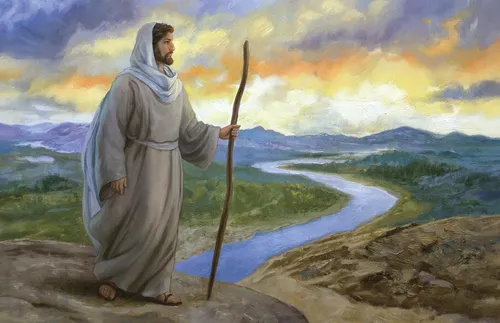 Jesus standing in front of a sunset