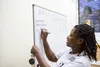 student writing on the white board
