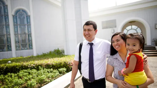 a smiling family walking near a temple