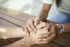 woman holding hands of another person