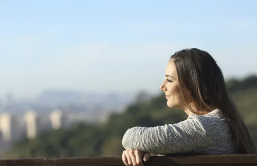 young adult woman sitting on a bench
