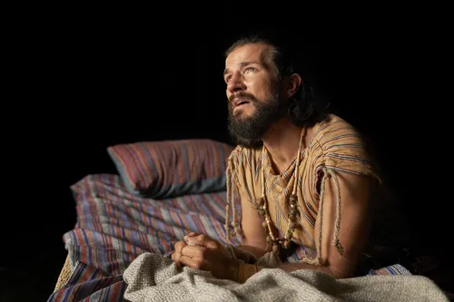 Alma the Younger kneels at his bedside.