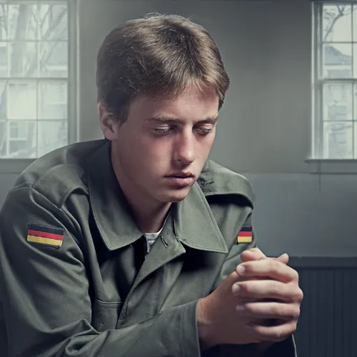 young German soldier praying