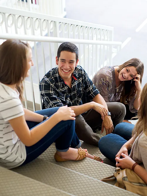 young adults sitting on stairs