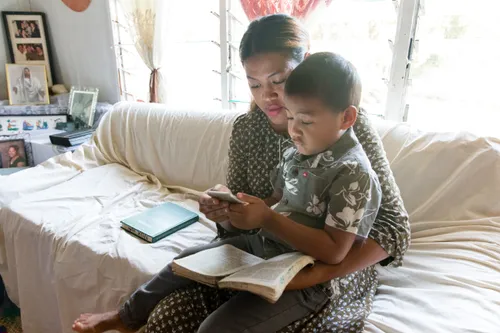 a mother and a son reading together