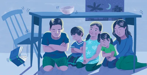 Family praying under a table during an earthquake