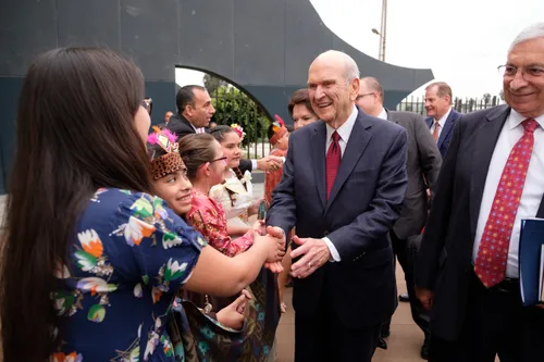 President and Sister Nelson embracing children