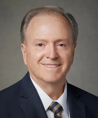 Lynn G Robbins takes an official portrait in 2021.