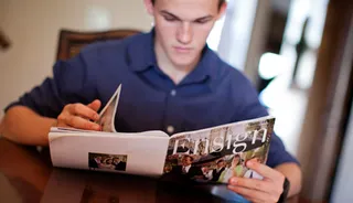 young man reading Ensign