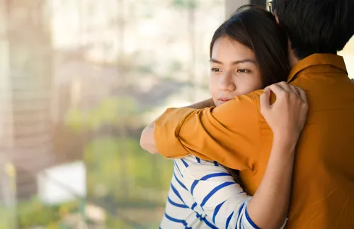 Two young adults embracing