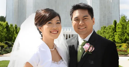 couple standing in front of temple