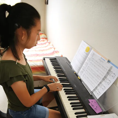 young woman playing keyboard