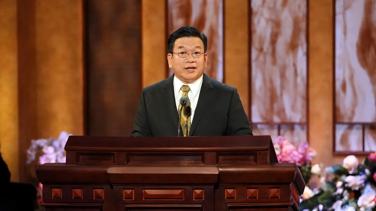 Elder Teh stands at pulpit to give general conference address