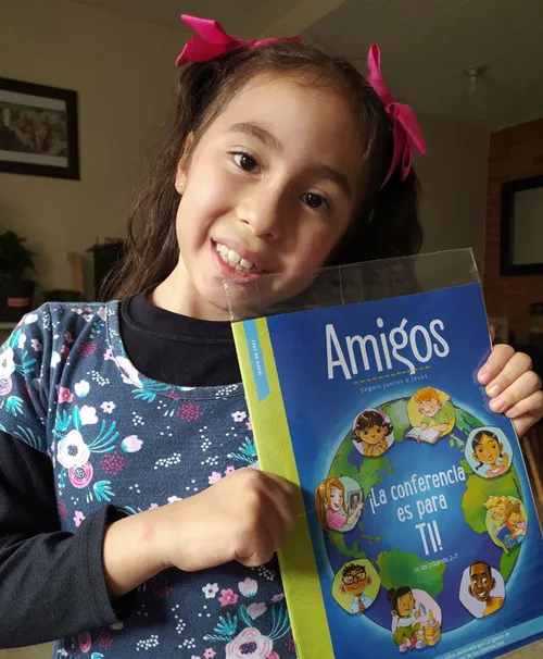 Girl holding a copy of the Friend