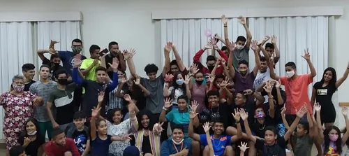 group of youth waving their hands