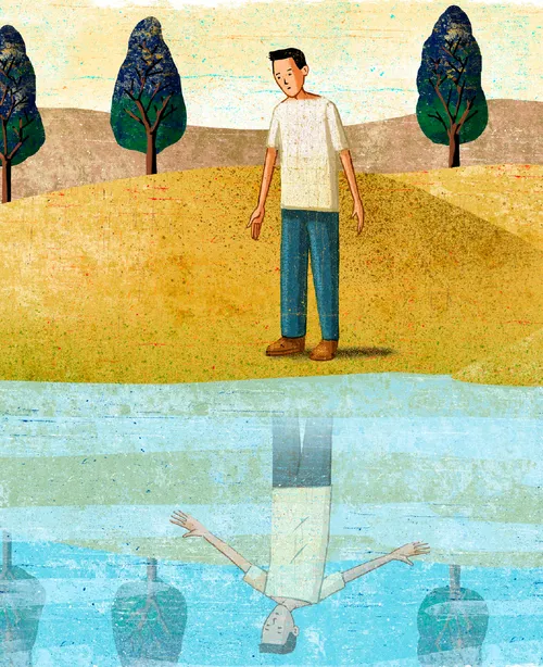 boy looking at reflection in water