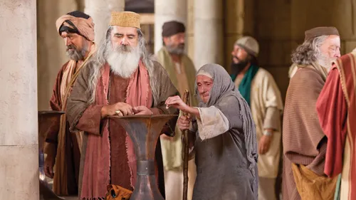 a woman placing a coin in a chest
