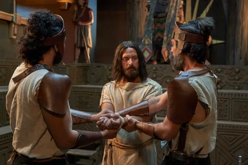 Various guards bind Abinadi as he is questioned by priests before King Noah.