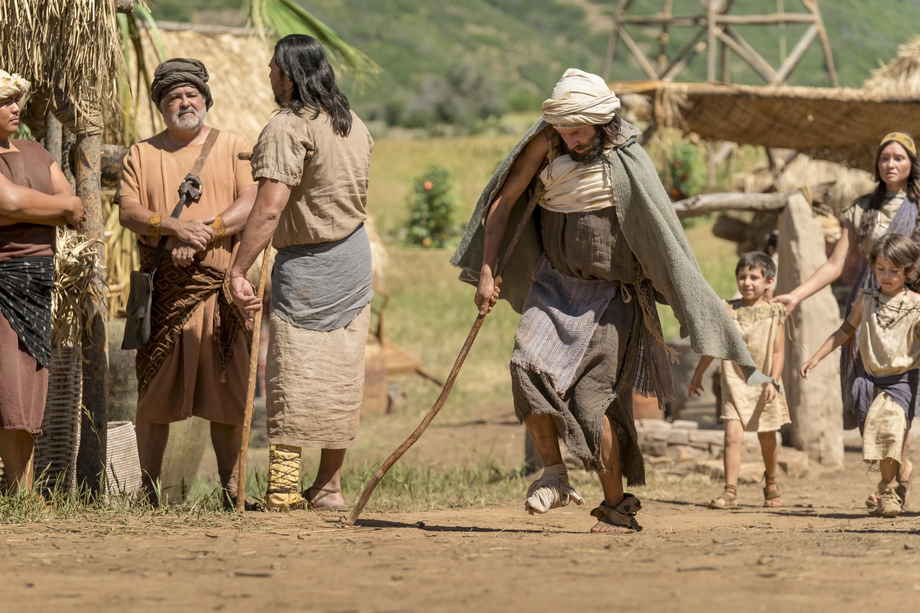 A disabled man walks toward the temple.