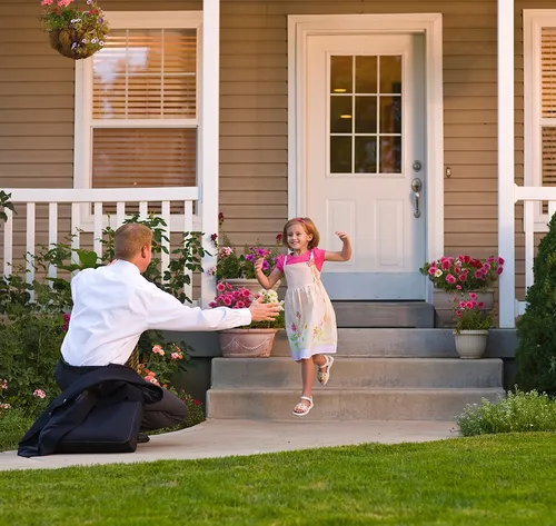 daughter welcoming father home from work
