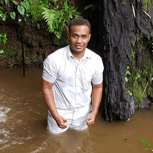 missionary in white clothes in water