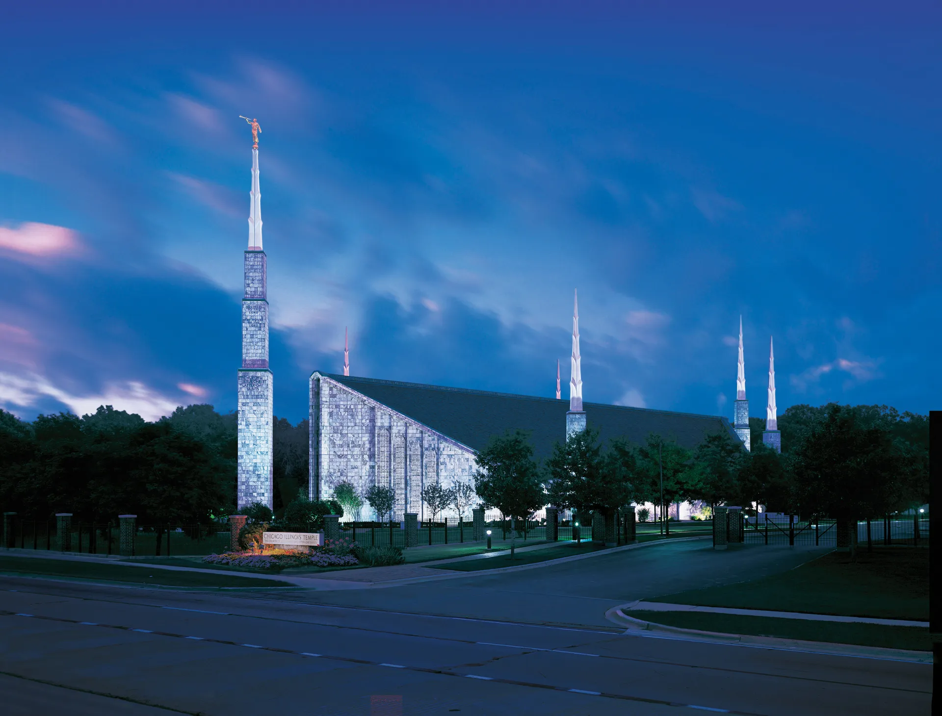 Lights shine on the Chicago Illinois Temple at night.