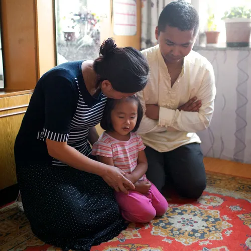 family praying together