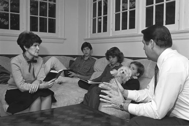 The Holland family participating in family scripture study, November 11, 1980.
